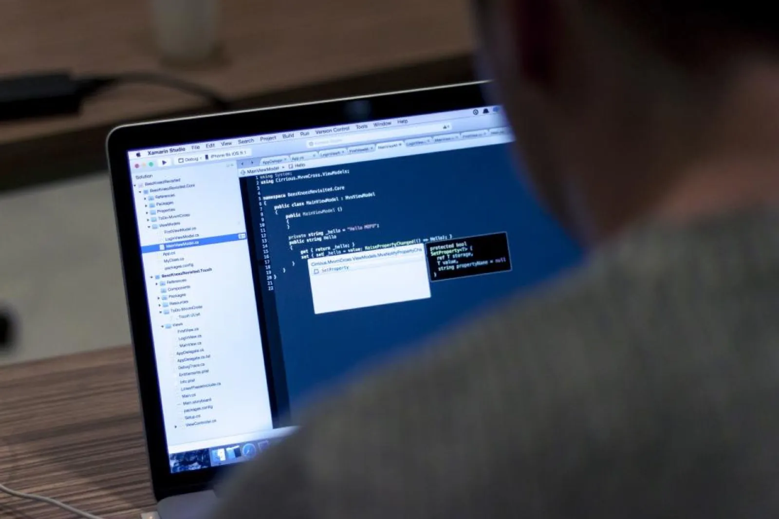 Engineer reviewing code on a laptop
